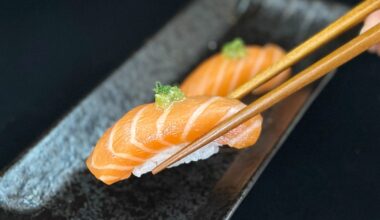 sushi being picked up with chopsticks