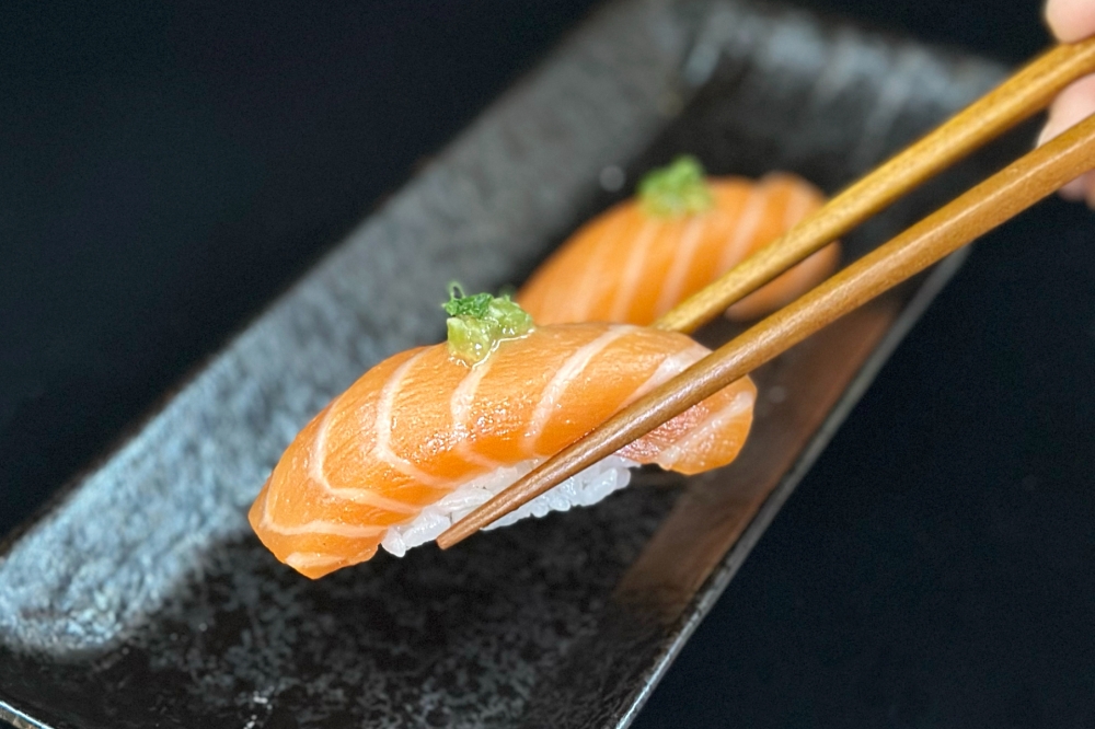 sushi being picked up with chopsticks