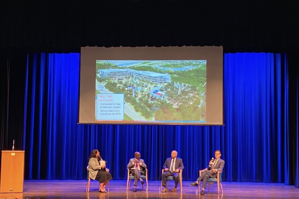 people sitting on a stage for a panel discussion