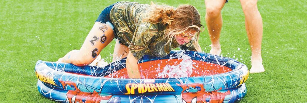 Port Aransas High School junior Kinley Oestreich tries to dunk a shirt during a water relay held for Field Day. Staff photos by Alex Berksan