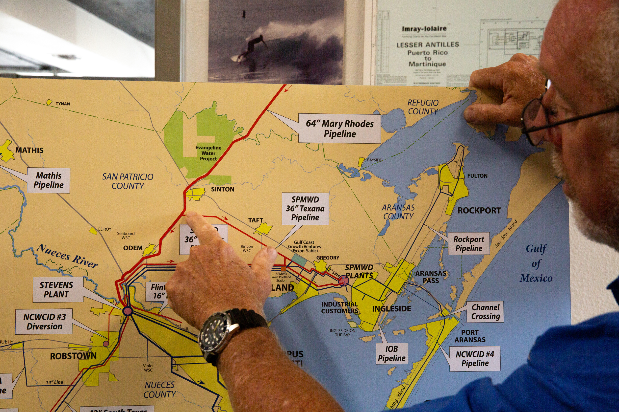 John Michael points to Sinton on a map at the Hanson Professional Services office in Corpus Christi on Monday. Credit: Dylan Baddour/Inside Climate News