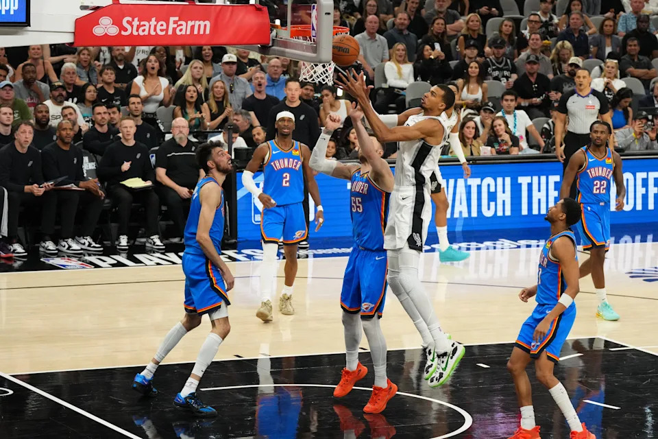 May 24, 2026; San Antonio, Texas, USA; San Antonio Spurs center Victor Wembanyama (1) shoots while defended by Oklahoma City Thunder center Isaiah Hartenstein (55) in the third quarter during game four of the western conference finals for the 2026 NBA playoffs at Frost Bank Center. Mandatory Credit: Scott Wachter-Imagn Images