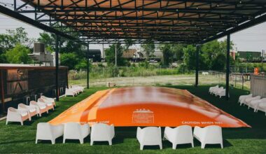 Large orange inflatable bounce, set up outdoors at a family friendly restaurant and beer garden