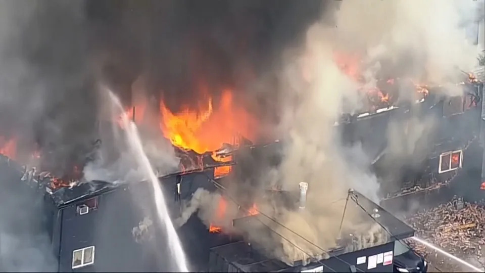 Flames engulf an apartment complex after an explosion in the Oak Cliff area of Dallas on Thursday as Dallas Fire-Rescue crews battled the blaze. Four people were hospitalized, according to reports. (KDFW FOX 4 via AP)