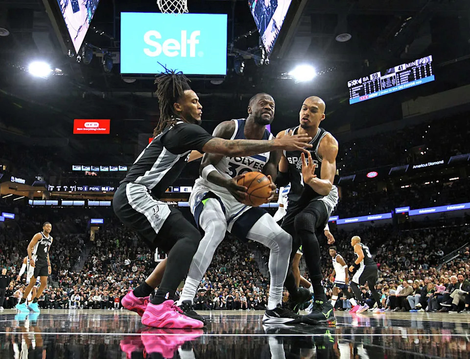 SAN ANTONIO, TX - JANUARY 17: <a class="link " href="https://sports.yahoo.com/nba/players/5318/" data-i13n="sec:content-canvas;subsec:anchor_text;elm:context_link" data-ylk="slk:Julius Randle;sec:content-canvas;subsec:anchor_text;elm:context_link;itc:0" data-yga="{"yLinkElement":"context_link","yModuleName":"content-canvas","yLinkText":"Julius Randle","ySubModuleName":"anchor_text","yHasCommerce":false}">Julius Randle</a> #30 of the Minnesota Timberwolves tries to score against <a class="link " href="https://sports.yahoo.com/nba/players/10290/" data-i13n="sec:content-canvas;subsec:anchor_text;elm:context_link" data-ylk="slk:Stephon Castle;sec:content-canvas;subsec:anchor_text;elm:context_link;itc:0" data-yga="{"yLinkElement":"context_link","yModuleName":"content-canvas","yLinkText":"Stephon Castle","ySubModuleName":"anchor_text","yHasCommerce":false}">Stephon Castle</a> #5 of the San Antonio Spurs and Victor Wembanyama #1 in the second half at Frost Bank Center on January 17, 2026 in San Antonio, Texas. NOTE TO USER: User expressly acknowledges and agrees that, by downloading and or using this photograph, User is consenting to terms and conditions of the Getty Images License Agreement. (Photo by Ronald Cortes/Getty Images) (Ronald Cortes/Getty Images)