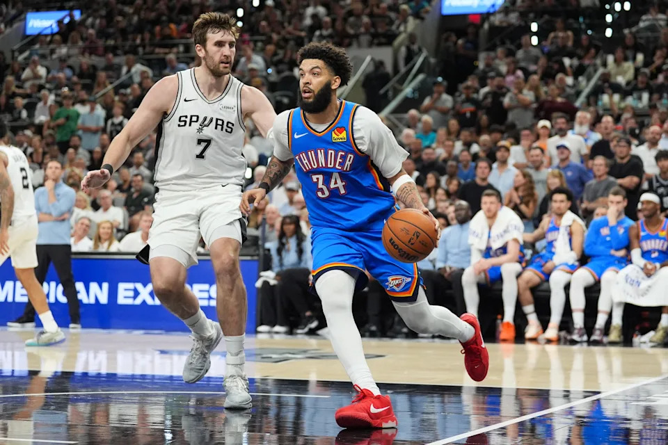 May 24, 2026; San Antonio, Texas, USA; Oklahoma City Thunder forward Kenrich Williams (34) moves the ball while defended by San Antonio Spurs center Luke Kornet (7) in the fourth quarter during game four of the western conference finals for the 2026 NBA playoffs at Frost Bank Center. Mandatory Credit: Daniel Dunn-Imagn Images