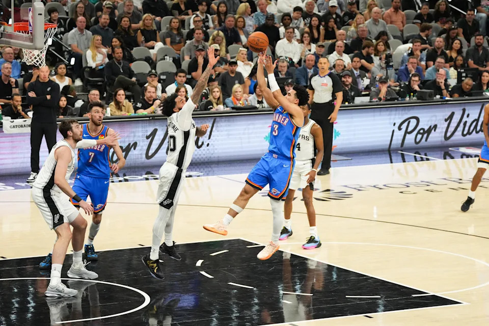 May 24, 2026; San Antonio, Texas, USA; Oklahoma City Thunder guard Jared McCain (3) shoots while defended by San Antonio Spurs forward Julian Champagnie (30) in the second quarter during game four of the western conference finals for the 2026 NBA playoffs at Frost Bank Center. Mandatory Credit: Scott Wachter-Imagn Images