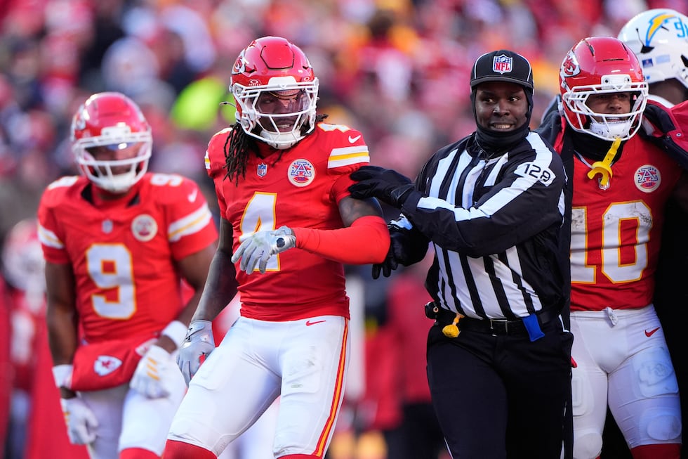 Kansas City Chiefs wide receiver Rashee Rice (4) is held back by an official during the second...
