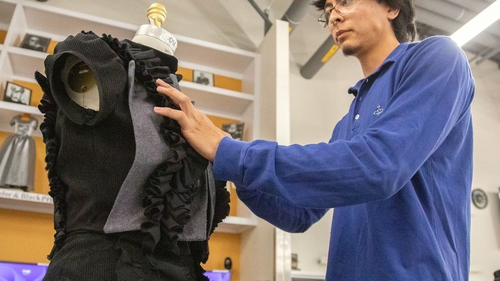 Elian Venegas, a graduating student in Fashion Technology, psrepared on of his designs for an upcoming fashion show.