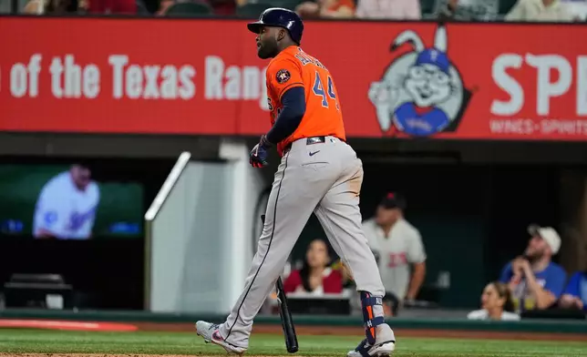 Houston Astros' Yordan Alvarez walks out of the batters box watching the flight of his solo home run in the eighth inning of a baseball game against the Texas Rangers Wednesday, May 27, 2026, in Arlington, Texas. (AP Photo/Tony Gutierrez)