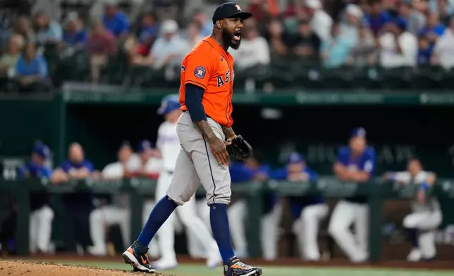 Houston Astros pitcher Enyel de Los Santos celebrates after striking out Texas Rangers' Jake Burger in the eighth inning of a baseball game Wednesday, May 27, 2026, in Arlington, Texas. (AP Photo/Tony Gutierrez)