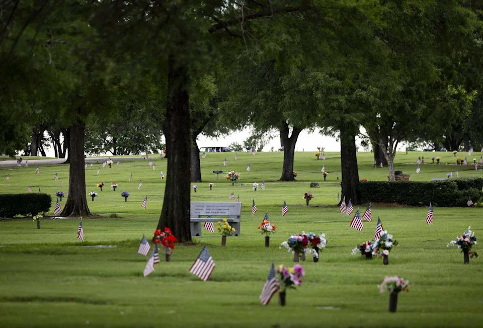 U.S. flag mark the graves of veterans buried at Bluebonnet Hills Funeral Home & Memorial Park on Saturday, May 23, 2026 in Colleyville.