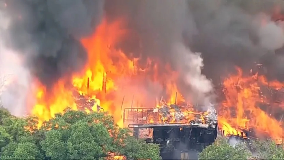 Flames engulf an apartment complex after an explosion in the Oak Cliff area of Dallas on Thursday as Dallas Fire-Rescue crews battled the blaze. Four people were hospitalized, according to reports. (KDFW FOX 4 via AP)
