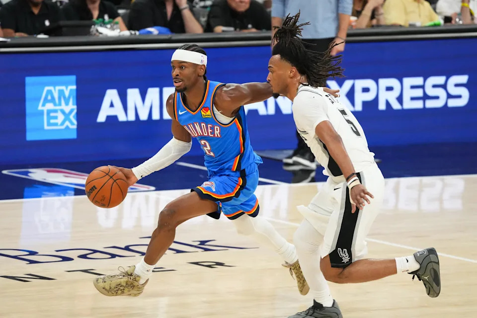 May 24, 2026; San Antonio, Texas, USA; Oklahoma City Thunder guard Shai Gilgeous-Alexander (2) moves the ball past San Antonio Spurs guard Stephon Castle (5) in the second quarter during game four of the western conference finals for the 2026 NBA playoffs at Frost Bank Center. Mandatory Credit: Scott Wachter-Imagn Images