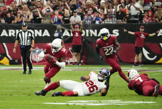 Arizona Cardinals safety Jalen Thompson (34) intercepts a pass intended for New York Giants running back Saquon Barkley (26) in the first half at State Farm Stadium in Glendale on Sept. 17, 2023.