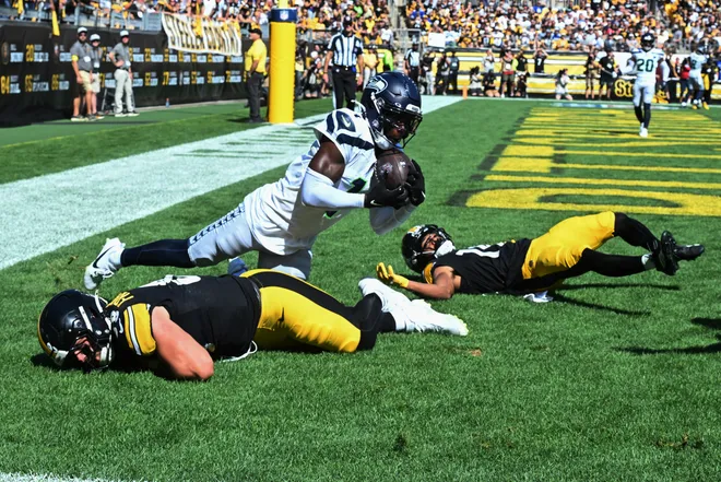 Sep 14, 2025; Pittsburgh, Pennsylvania, USA; Seattle Seahawks cornerback Derion Kendrick (1) intercepts a pass over Pittsburgh Steelers tight end Pat Freiermuth (88) and wide receiver Calvin Austin III (19) during the second half at Acrisure Stadium. Mandatory Credit: Barry Reeger-Imagn Images