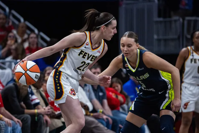 Apr 30, 2026; Indianapolis, IN, USA; Indiana Fever guard Caitlin Clark (22) dribbles the ball while Dallas Wings guard Paige Bueckers (5) defends in the first half at the Gainbridge Fieldhouse. Mandatory Credit: Trevor Ruszkowski-Imagn Images