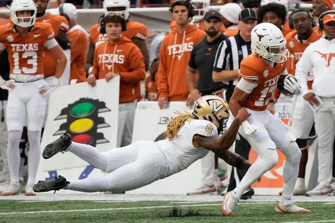 Nov 1, 2025; Austin, Texas, USA; Vanderbilt Commodores defensive back CJ Heard (8) tackles Texas Longhorns wide receiver Daylan McCutcheon (17) during the second half at Darrell K Royal-Texas Memorial Stadium. Mandatory Credit: Scott Wachter-Imagn Images