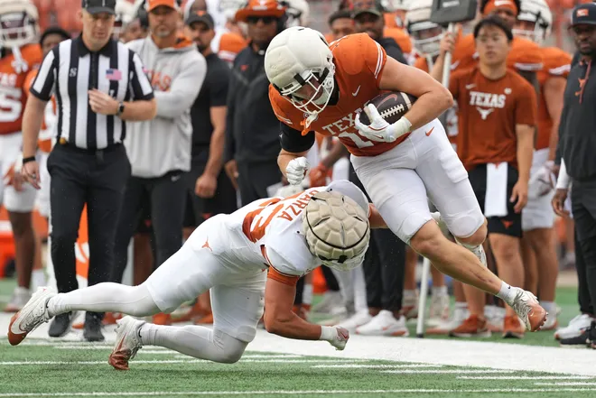 AUSTIN, TEXAS - APRIL 18: Michael Masunas #15 of the Texas Longhorns runs for yards while defended by Eric Garza #43 after making a catch during the Texas Spring Football Game at Darrell K Royal-Texas Memorial Stadium on April 18, 2026 in Austin, Texas. (Photo by Scott Wachter/Getty Images for ONIT)