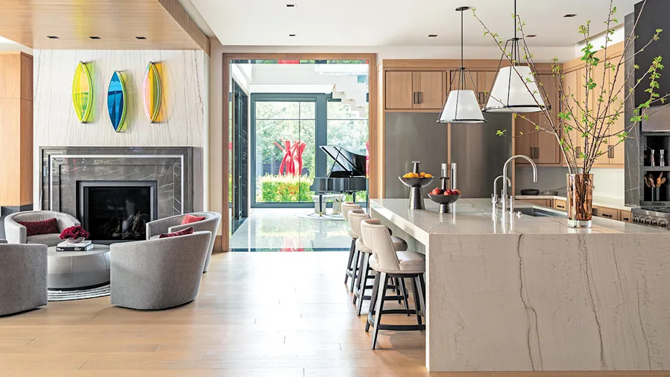 Boat-shaped plexiglass and stainless-steel pieces by Claire Ankenman hang above the hearth, while a vivid red sculpture by Matt Devine punctuates the landscape in the distance.