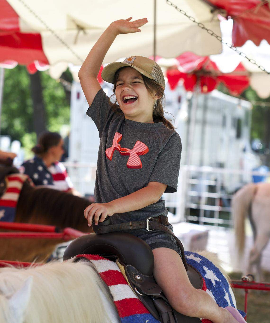 Keiaula Rincon, 8, rides a pony at Mayfest on Saturday, May 2, 2026, in Fort Worth. Mayfest brings live music, carnival rides, food, local art and more along the Trinity River.