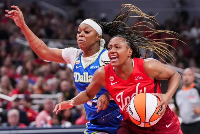 Dallas Wings guard Odyssey Sims (1) guards Indiana Fever guard Kelsey Mitchell (0) on Saturday, May 9, 2026, during the second half of the Fever's season opener game at Gainbridge Fieldhouse in Indianapolis. The Dallas Wings defeated the Indiana Fever, 107-104.