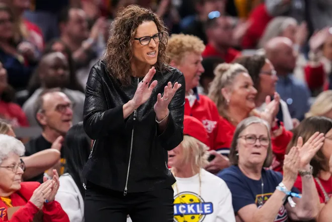 Indiana Fever head coach Stephanie White celebrates on Saturday, May 9, 2026, during the first half of the Fever's season opener game at Gainbridge Fieldhouse in Indianapolis.