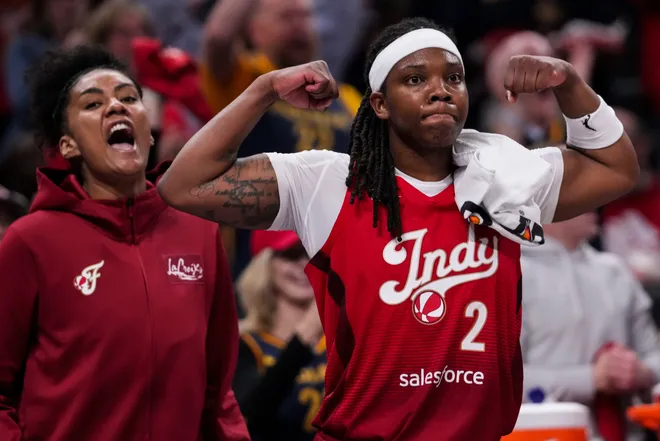 Indiana Fever center-forward Damiris Dantas (12) and Indiana Fever forward Myisha Hines-Allen (2) celebrate from the bench on Saturday, May 9, 2026, during the second half of the Fever's season opener game at Gainbridge Fieldhouse in Indianapolis. The Dallas Wings defeated the Indiana Fever, 107-104.