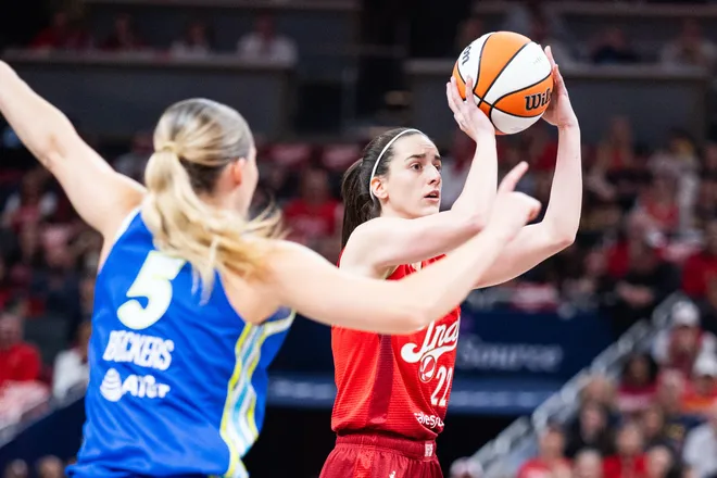 May 9, 2026; Indianapolis, Indiana, USA; Indiana Fever guard Caitlin Clark (22) shoots the ball while Dallas Wings guard Paige Bueckers (5) defends in the first half at Gainbridge Fieldhouse. Mandatory Credit: Trevor Ruszkowski-Imagn Images