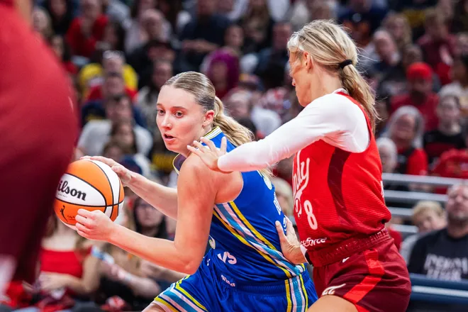 May 9, 2026; Indianapolis, Indiana, USA; Dallas Wings guard Paige Bueckers (5) dribbles the ball while Indiana Fever guard Sophie Cunningham (8) defends in the second half at Gainbridge Fieldhouse. Mandatory Credit: Trevor Ruszkowski-Imagn Images