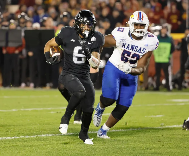 AMES, IA - NOVEMBER 4: Running back Eli Sanders #6 of the Iowa State Cyclones rushed for yards as defensive lineman D.J. Withers #52 of the Kansas Jayhawks defends in the second half of play at Jack Trice Stadium on November 4, 2023 in Ames, Iowa. The Kansas Jayhawks won 28-21 over the Iowa State Cyclones. (Photo by David Purdy/Getty Images)