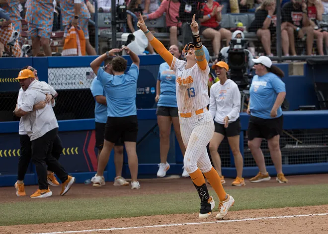May 30, 2026; Tennessee Lady Volunteers infielder Emma Clarke (13) raises her arms as she heads home after a walk-off home run in the ninth inning beating the Texas Tech Red Raiders during the NCAA Women’s College World Series at Devon Park.