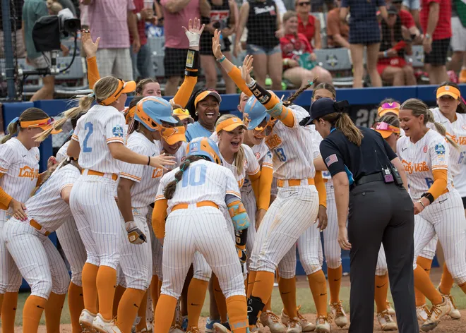 May 30, 2026; Tennessee Lady Vols infielder Emma Clarke (13) raises her arms as she touches home plate and is surrounded by teammates after a walk-off home run in the ninth inning beating Texas Tech during the NCAA Women’s College World Series at Devon Park.