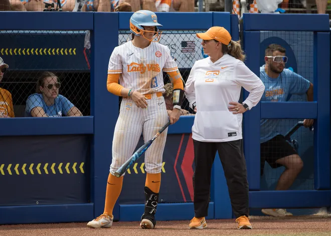 May 30, 2026; Oklahoma City, OK, USA; Tennessee Lady Volunteers head coach Karen Weekly talks with infielder Emma Clarke (13) in the third inning against the Texas Tech Red Raiders during the NCAA Women’s College World Series at Devon Park.