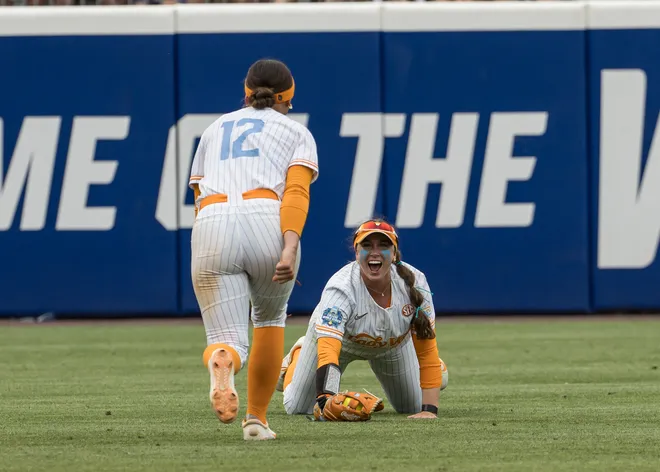 May 30, 2026; Tennessee Lady Volunteers outfielder Alannah Leach (10) looks up at infielder Bella Faw (12) after making a diving catch for an out in the seventh inning against the Texas Tech Red Raiders during the NCAA WomenÕs College World Series at Devon Park.