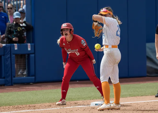 May 30, 2026; Oklahoma City; Texas Tech Red Raiders third baseman Taylor Pannell (6) yells towards her dugout after a stolen base as Tennessee Lady Vols infielder Ella Dodge (25) looks on in the seventh inning during the NCAA Women's College World Series at Devon Park.