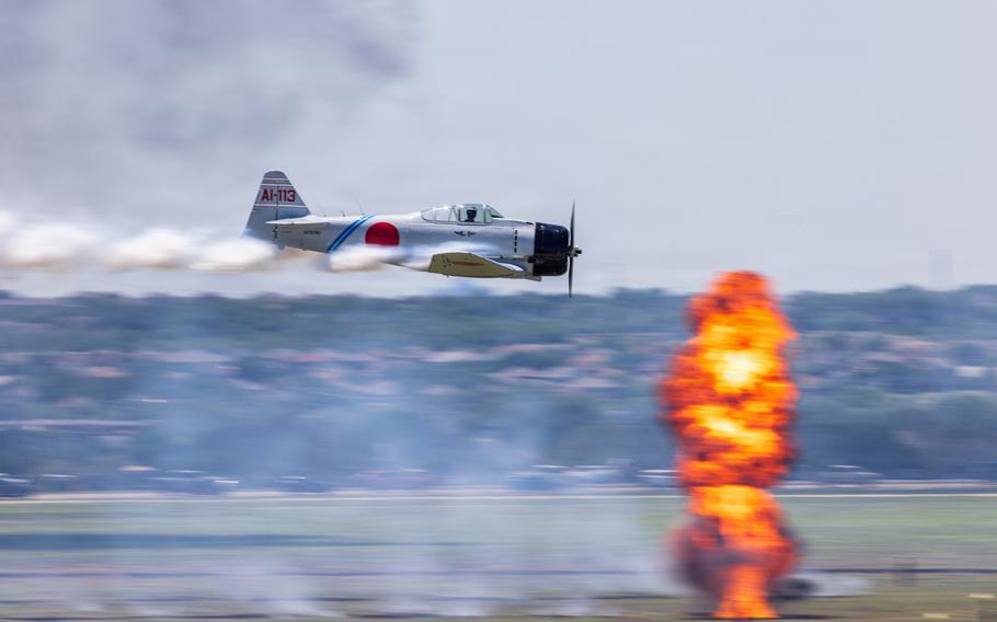 An aircraft approaches an orange explosion.