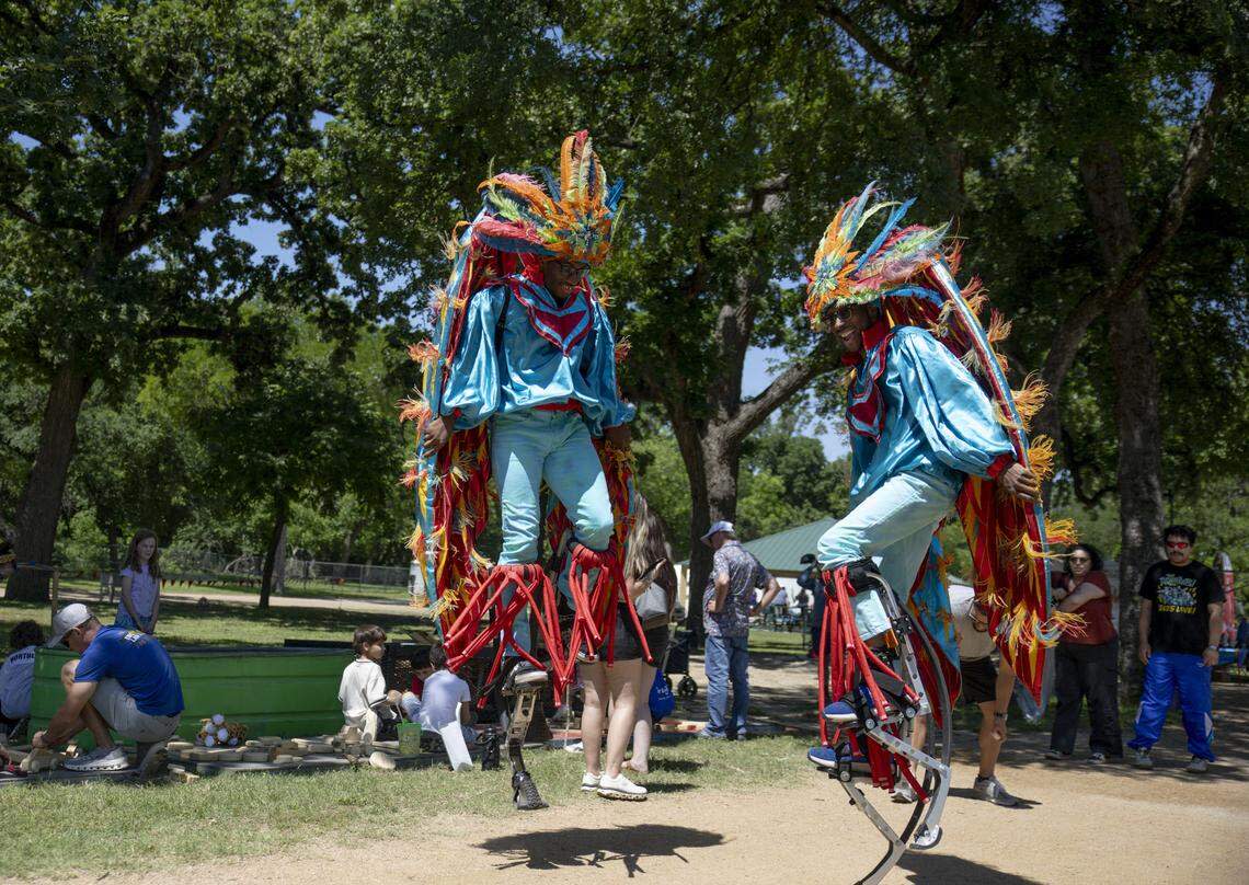 Michael Johnson and Justin Chatman walk around Mayfest on bounce stilts on Saturday, May 2, 2026, in Fort Worth. The festival started on Thursday, April 30 and runs through Sunday, May 3.