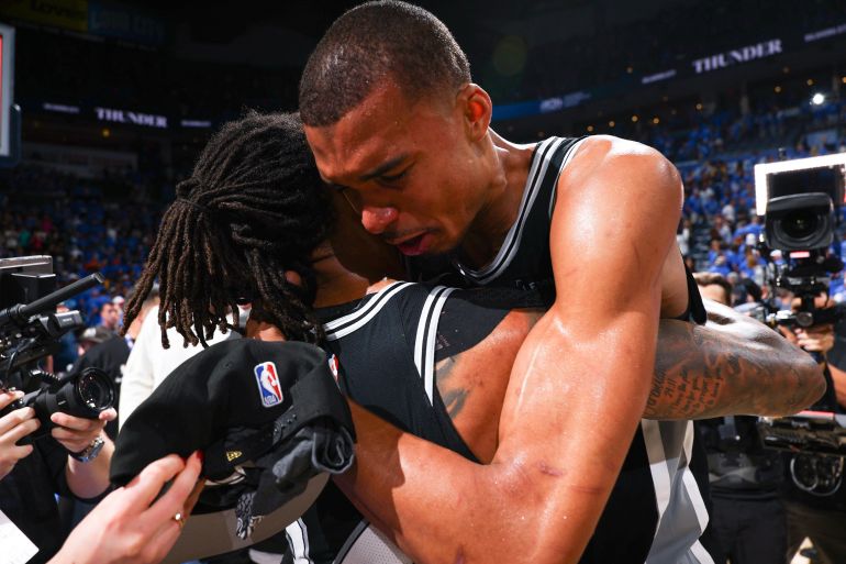 OKLAHOMA CITY, OK - MAY 30: Victor Wembanyama #1 and Devin Vassell #24 of the San Antonio Spurs hug after the game against the Oklahoma City Thunder during Game Seven of the NBA Western Conference Finals on May 30, 2026 at Paycom Center in Oklahoma City, Oklahoma. NOTE TO USER: User expressly acknowledges and agrees that, by downloading and or using this photograph, User is consenting to the terms and conditions of the Getty Images License Agreement. Mandatory Copyright Notice: Copyright 2026 NBAE Zach Beeker/NBAE via Getty Images/AFP (Photo by Zach Beeker / NBAE / Getty Images / Getty Images via AFP)