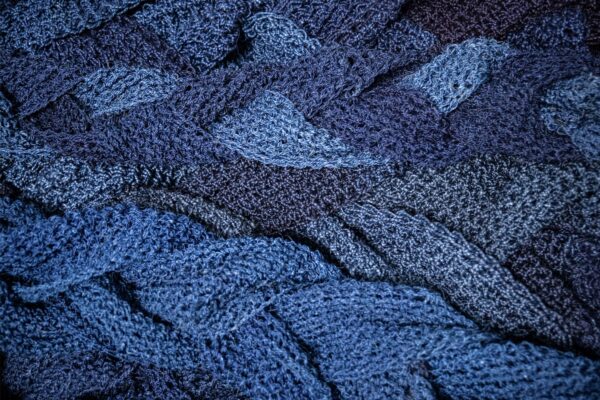 A close up view of blue-dyed interwoven fabric.