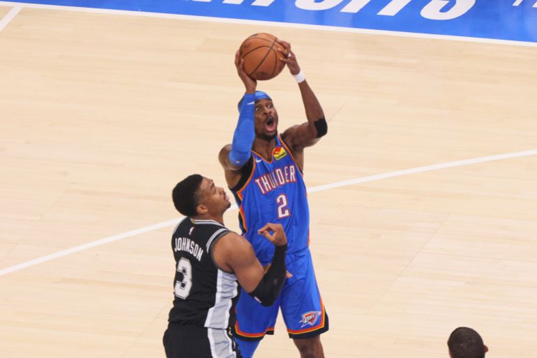 Oklahoma City Thunder guard Shai Gilgeous-Alexander (2) shoots against San Antonio Spurs forward Keldon Johnson (3) in the first half of Game 7 of the Western Conference finals of the NBA basketball playoffs series Saturday, May 30, 2026, in Oklahoma City. (AP Photo/Nate Billings)