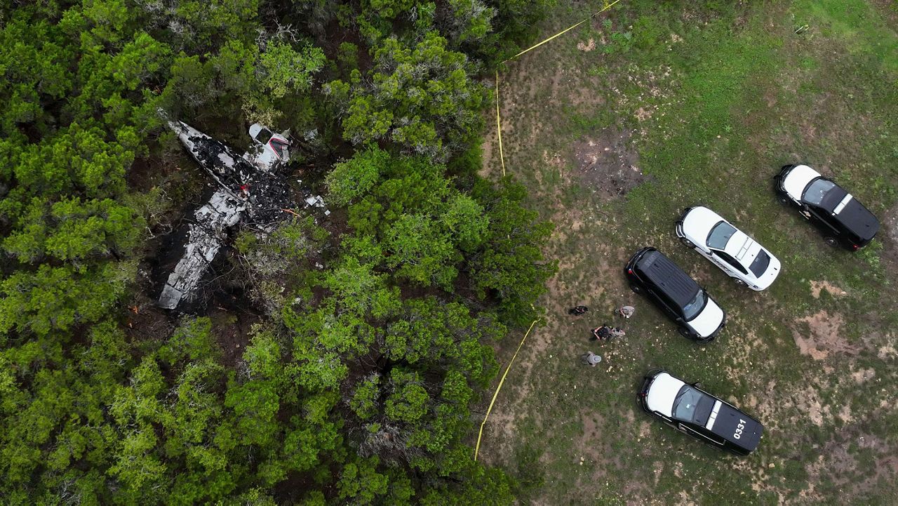 A crashed Cessna airplane is seen in a wooded area on Round Rock Road in Wimberley, Texas, Friday, May 1, 2026. (Jay Janner/Austin American-Statesman via AP)