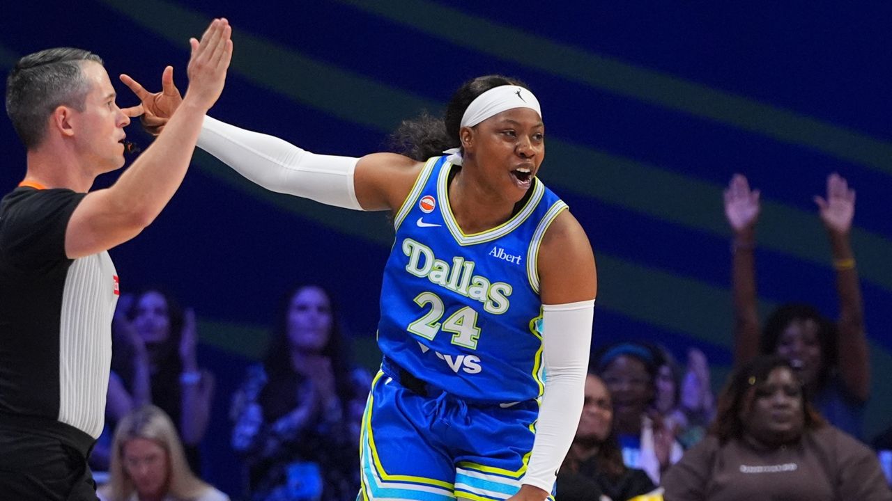 Dallas Wings guard Arike Ogunbowale reacts to scoring a three pointer during the first half of a WNBA basketball game against the Washington Mystics in Arlington, Texas, Monday, May 18, 2026. (AP Photo/LM Otero)