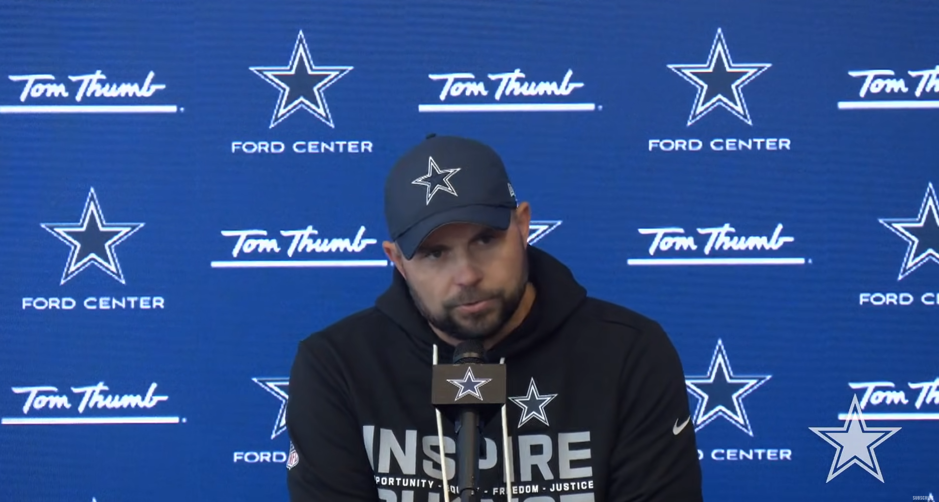 Dallas Cowboys OC Klayton Adams talking to reporters.
