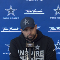 Dallas Cowboys OC Klayton Adams talking to reporters.