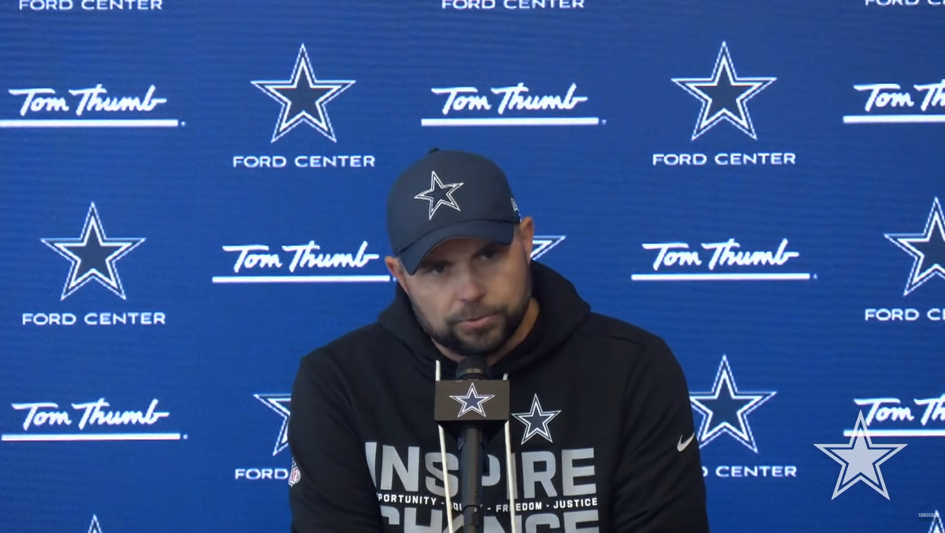 Dallas Cowboys OC Klayton Adams talking to reporters.