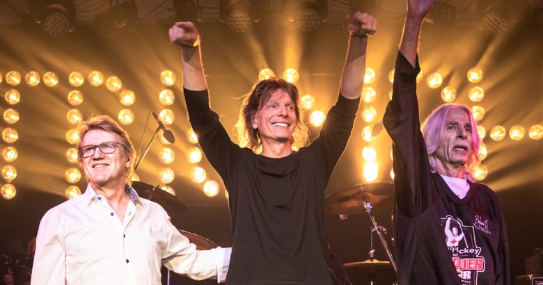 The three original members of Triumph greet the audience during one of their more recent live appearances. 