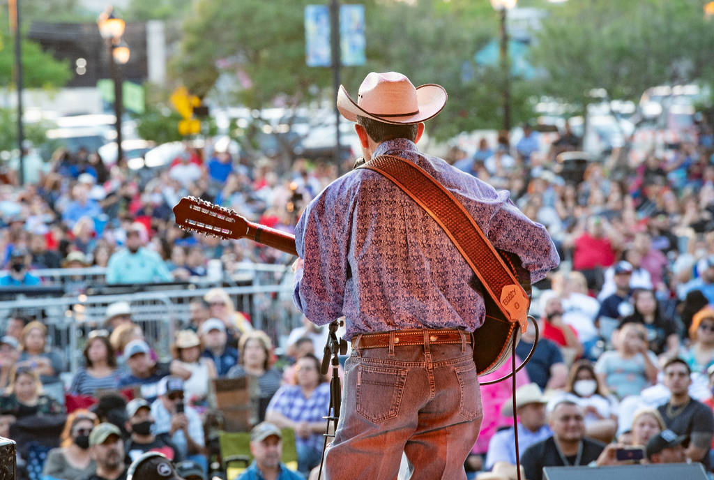 Image shows a musician performing on stage at Levitt Pavilion in Arlington, Texas. 