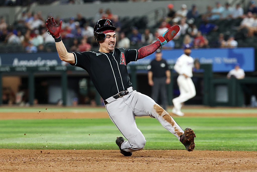 ARLINGTON, TEXAS - MAY 13: Corbin Carroll #7 of the Arizona Diamondbacks slides into third base during a game against the Texas Rangers at Globe Life Field on May 13, 2026 in Arlington, Texas. (Photo by Stacy Revere/Getty Images)