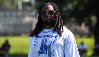 James Houston IV wearing sunglasses and a white Dallas Cowboys shirt during practice.